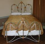 375 - Antique iron bed ornately decorated, belonged to Madam Cate from Decatur Legendary Past, ca. 1900. 67in. T, 54in. W.