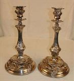 136 - Pair of silver candle sticks in the rococo style.