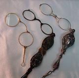 1106 - Gold Victorian folding opera glasses. 
1107 - Celluloid Plastic pair of Victorian opera glasses 
1108 - Silver plate Victorian folding opera glasses with strap.