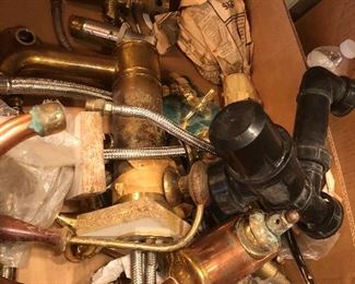 Lots of brass and gold plated bathroom plumbing handles and piping
