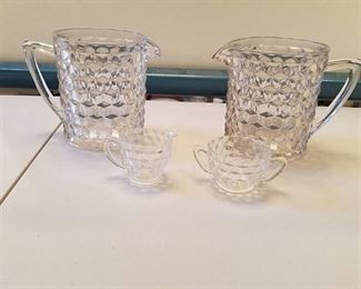 2 glass pitchers with sugar and cream dishes