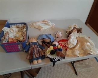 Assorted Dolls and Clothes in Basket