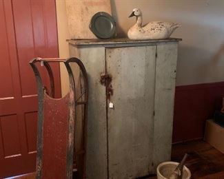Early cupboard, all original.  Great interior.  Stenciled early children's sled.  Late 1700's English pewter warming dish, hallmarked and with "LONDON" inscribed.  Primitive bread board.  Contemporary snow goose, unsigned.  Pharmacist's stone mortar and pestle. 