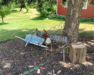 Garden decorations:  old blue paint wheel barrow; contemporary iron chair; etc.