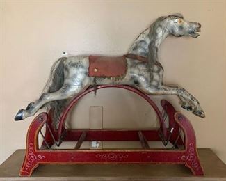 This delightful dapple grey rocking horse is just waiting for a new "paddock".  All original, but missing his stirrups.