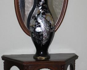 Antique Demi Lune/Half Hexagonal Tbale w/Turned Legs and Stretchers (30”W x 30”H x 15”D).  Antique Carved Wood Framed Bevel Mirror w/Carved Floral Crown (21” x 40”)