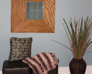 Bombay Company Bevel Rattan Framed Bevel Mirror (35.3” x 35.5”) shown with Worldwide Cappuccino Faux Leather Cube Ottoman (18” x 18”). Brown Rattan Vase (19”H) with Wild Reeds & Grasses