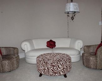 Kidney Bean/Crescent Shape Boucle’ Vanilla Upholstery Sofa, Dimensions Zebra Print 36” Round Ottoman and a Pair of Leopard Print Slope Back Swivel Barrel Chairs