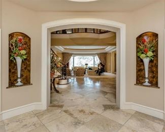 Entry View Entering Home Showing Tall White Blown Art Glass Trumpet Vases with Floral Arrangements.  (2 of 4 shown) 