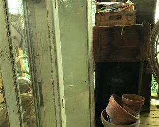 Display case on it's side, flower pots, wood crates