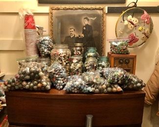 Marbles, marbles, marbles, coke cups, mid century chest, jars of old buttons and picture of a happy? couple!