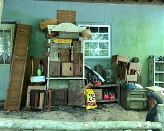 Tall shutters, wooden crates ( more on back porch) Pepsi and coke wood crates, the coke bottles are seating on a cute bench with a bird house built in, ladder on the far end.