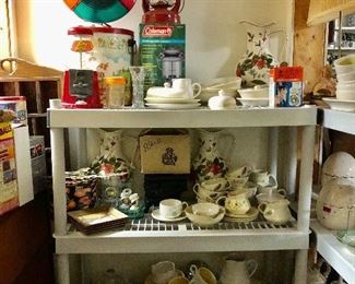 Vintage Christmas color wheel,  red lantern, Coleman lantern, Franciscan Earthenware Hacienda Gold shelf 3, and Franciscan Earthenware Hacienda Green top shelf and top shelf on right of picture, 2nd shelf Franciscan Autumn Leaves and a cup and saucer pattern Atomic 
