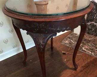 #4)  $50 - Solid wood carved round table with glass top.  26" diameter x 30" tall.  