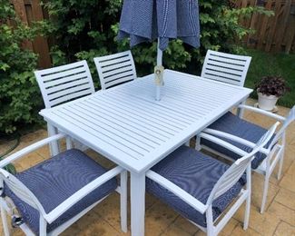 #2) $500 -  White aluminum outdoor patio table with 6 chairs, umbrella, umbrella stand and 6 matching chair cushions.  In excellent condition.  Cushions show some wear.  