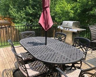 #30)  $350 - Cast iron Patio table with 6 swivel arm chairs. Cushions included.  Umbrella and Umbrella stand included.  Table is sun faded but otherwise in good condition.  Cushions are faded.  Umbrella is worn.  