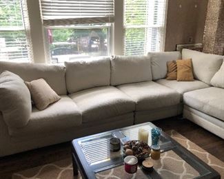 #35) $200 - Sectional sofa with pillows.  Off-white fabric shows wear.  Structurally in good condition.  Smoke Free home.  