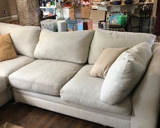 #35) $200 - Sectional sofa with pillows.  Off-white fabric shows wear.  Structurally in good condition.  Smoke Free home.  