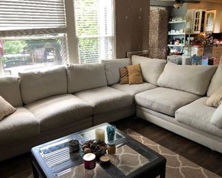 #35) $200 - Sectional sofa with pillows.  Off-white fabric shows wear.  Structurally in good condition.  Smoke Free home.  