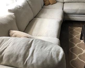 #35) $200 - Sectional sofa with pillows.  Off-white fabric shows wear.  Structurally in good condition.  Smoke Free home.  