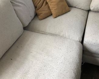 #35) $200 - Sectional sofa with pillows.  Off-white fabric shows wear.  Structurally in good condition.  Smoke Free home.  