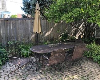 Iron patio table 38” x 66” with 6 chairs and umbrella 