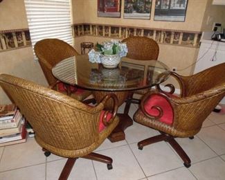 Really nice dinette set. Pedestal Base, Pie Crust Glass Top, 4 chairs on castors, Red upholstered seats.