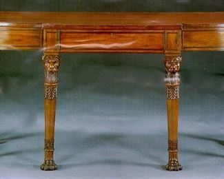 SOLD - A REGENCY MAHOGANY SIDE TABLE
IN THE MANNER OF GEORGE SMITH, EARLY 19TH CENTURY
Of broken D-shaped outline, the top with reeded edge above a central frieze drawer, on lion monopodia legs carved with acanthus decoration
39 in. high; 76 in. wide; 30 in. deep