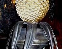 A PAIR OF TÔLE-PEINTE PINEAPPLE- TOPPED URN ORNAMENTS, 20TH CENTURY
29 in. high; 9 1/4 in. diameter (approximately at largest corner) 
PROVENANCE:Anne Jaudel, Paris                 Appraised Value: $1500.00