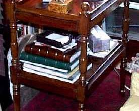 A VICTORIAN MAHOGANY TWO-TIER WHATNOT
LATE 19TH CENTURY
Fitted with two shelves supported by turned posts with knob finials, on four turned posts and legs
36 in. high; 28 1/2 in. wide; 19 3/4 in. deep        Appraised Value:$500.00