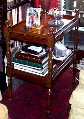 A VICTORIAN MAHOGANY TWO-TIER WHATNOT
LATE 19TH CENTURY
Fitted with two shelves supported by turned posts with knob finials, on four turned posts and legs
36 in. high; 28 1/2 in. wide; 19 3/4 in. deep        Appraised Value:$500.00