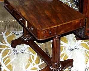 A GEORGE IV MAHOGANY INVALID'S TABLE
CIRCA 1830
The rounded rectangular top with flap to the back over three frieze drawers, on turned tapering gadrooned trestle supports joined by a stretcher, the tapering brass feet with gadrooned collars, on casters
29 in. high; 36 in. wide; 20 1/2 in. deep (closed)      Appraised Value: $2500.00