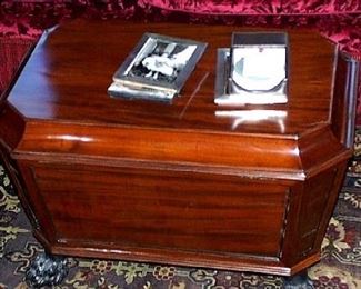 A GEORGE IV MAHOGANY CELLARETTE CIRCA 1820
The rectangular lid with canted corners, opening to an originally divided and lead-lined interior, the tapering paneled case on ebonized hairy paw feet with casters 19 1/2 in. high; 29 1/2 in. wide                   Appraised Value: $3000.00