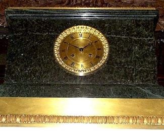 ]A LOUIS-PHILIPPE ORMOLU-MOUNTED 'VERDE ANTICO' MARBLE MANTEL CLOCK THIRD QUARTER 19TH CENTURY
The 5-inch dial with Roman numerals; the stepped base with leaf-cast mount, the movement signed Dernière à Paris
16 in. high; 20 3/4 in. wide                                     Appraised Value: $2500.00