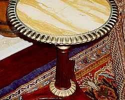 A PAIR OF ENGLISH BRASS-MOUNTED ONYX AND ROSEWOOD OCCASIONAL TABLES
EARLY 19TH CENTURY AND LATER
Each circular onyx top with gadrooned brass rim, on a baluster and tapering gadrooned stem with similar collar, on tripartite base with ribbed bun feet
21 in. high; 17 1/2 in. diameter (each)                 Appraised Value: $4000.00