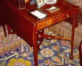 AN EARLY GEORGE III MAHOGANY PEMBROKE TABLE, CIRCA 1765
The serpentine top and flaps above a frieze drawer, on square legs joined by pierced X-form stretcher, with turned and block feet
27 1/2 in. high; 41 in. wide; 26 in. deep (open)     Appraised Value: $2500.00