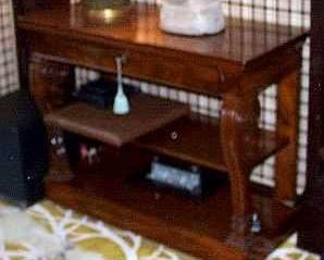 AN EMPIRE ACAJOU MOUCHETE CONSOLE CIRCA 1810
The hinged rectangular top above a frieze drawer over two open shelves, on scrolling front supports on a plinth, later shelf
36 in. high; 47 in. wide; 20 in. deep                       Appraised Value&nbsp;: $4000.00