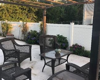 Outdoor set. Two chairs, ottoman, two tables, and loveseat.