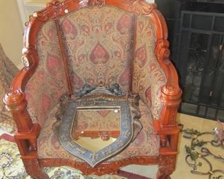 Victorian style chairs in lush fabric, Medival style mirror with a royal crest at the top, very elegant.