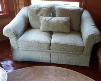 Love seat in a light. Green  pattern