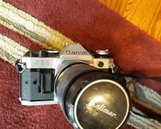 Canon AE-1.  SLR camera with three lens