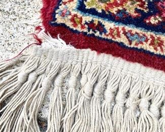 Lot 1013 	Buy it Now $85.00  Karastan. Small throw rug, red, tan, pinks and blues. damage on 2 corner fringe (check out picture)	60" l x 30" w