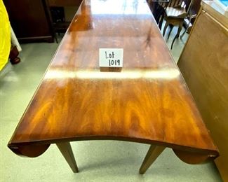 Lot 1019 Buy it Now $750.00 Talk about a multi-purpose piece!  Unbranded.  Interesting shaped!  Can be a sofa table, game table, side table. Has two pull out trays and drop leaf sides. Does have some chips on the top, but they seem to disappear with a little old english. Hardwood! 42" W (w/leaves up), 23.5"W (w/leaves dropped)  x 66"L x 30.5" H