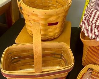 Lot 1111. Buy it Now $72.00  4 Longaberger basket assortment.  1990 handled basket with red ticking liner, 1994 med curved handle basket, 1998 small curved handle basket, 1998 round Dresden tour basket. Lg 1990 16x13x11, 1994  basket 9x5x5, 1998 basket 8x5x3, Dresden tour 8' round 6.5" tall, $72