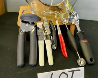 Lot 1127. Large Glass Salad or Fruit Bowl, 10"x5-1/4" + Towle set of 10.5" silver plate salad servers, and Gadgets include a can opener by Michael Graves Design, an oxo scoop, melon baller, corkscrew & red knife. $32