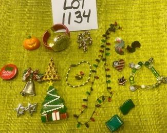 Lot 1134.  Holiday Theme Costume Jewelry. 1 gingerbread watch, 1 candy cane pin, xmas lights necklace, xmas tree pin, xmas tree w/gifts pin, "Damn I've been good!" Pin, Pumpkin pin, 5 pr. Earrings, 1 bracelet, bell pin, rose pin.  $30