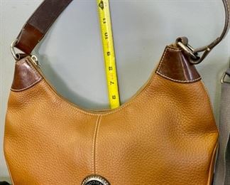 Lot 1184.  1 Charcoal handbag by Baggallini, nylon, great organized storage, 14 x 9.5, 1 Dooney & Bourke brown leather w/dark leather trim 13.5 x 6. $120