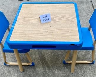 Lot 1252. Fisher-Price child's table with 2 matching chairs. The table has cubbies on sides--looks like it was an art table--condition shows considerable use, but F-P lasts forever! Tabletop 26" square, 20.5" tall. $70