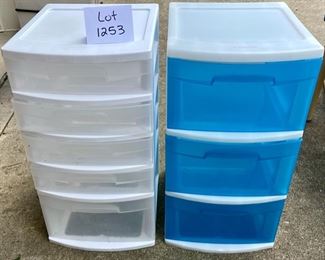 Lot 1253. Lof of 2 Sterilite plastic drawer units. One has 5 drawers and is all white; the other is white with 3 blue drawers. Each unit measure 24" tall, 12.5" wide, and 14.5" deep.  $20