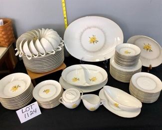 Lot 1124.  Lovely Sanga Dawn China.  96 pc. Includes-- 12 dinner plates, 18 teacups, 12 saucers, 11 bread and butter plates, 11 soup bowls, 12 fruit bowls, 12 salad plates. Serving Items: Large Platter (16"x12"), Divided veggie bowl, small platter, gravy and underplate, veggie bowl, sugar, and creamer. Plate stands and wood stand are not included.   $225.00